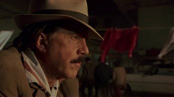 Movie still from “Time of the Gypsies” (1988), directed by Emir Kusturica – A person wearing a hat; Close Up shot, Low angle