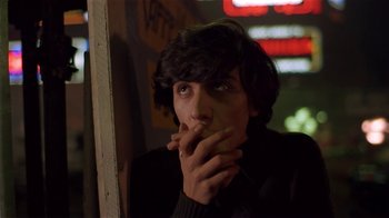 Movie still from “Time of the Gypsies” (1988), directed by Emir Kusturica – A man with his hand to his mouth; Close Up shot, Low angle