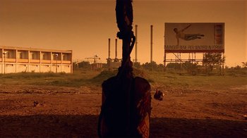Movie still from “Time of the Gypsies” (1988), directed by Emir Kusturica – An image of an outdoor scene with a billboard in the background; Extreme Wide shot, Low angle