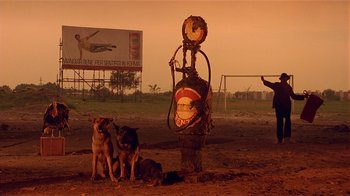 Movie still from “Time of the Gypsies” (1988), directed by Emir Kusturica – A group of dogs sitting next to a fire hydrant; Wide shot, Low angle