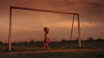 Movie still from “Time of the Gypsies” (1988), directed by Emir Kusturica – A little girl standing in front of a soccer goal; Extreme Wide shot, Low angle