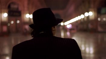 Movie still from “Time of the Gypsies” (1988), directed by Emir Kusturica – A man wearing a hat standing in the dark; Close Up shot, Low angle