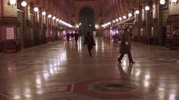 Movie still from “Time of the Gypsies” (1988), directed by Emir Kusturica – People are walking down a long hallway in a building; Extreme Wide shot, High angle