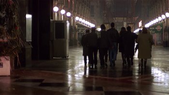 Movie still from “Time of the Gypsies” (1988), directed by Emir Kusturica – A group of people walking down a street at night; Wide shot, Low angle