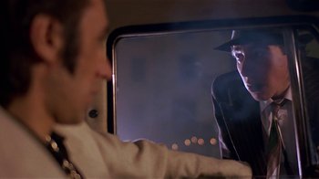 Movie still from “Time of the Gypsies” (1988), directed by Emir Kusturica – A man is looking out the window of a car at night; Close Up shot, Over the shoulder angle