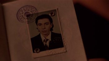 Movie still from “Time of the Gypsies” (1988), directed by Emir Kusturica – An old photo of a man in a suit and tie; Extreme Close Up shot, High angle