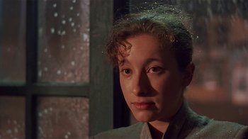 Movie still from “Time of the Gypsies” (1988), directed by Emir Kusturica – A person wearing a jacket; Close Up shot, Over the shoulder angle