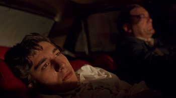 Movie still from “Time of the Gypsies” (1988), directed by Emir Kusturica – A man laying in a bed next to another man; Close Up shot, Low angle