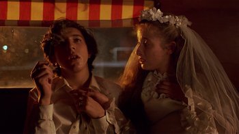Movie still from “Time of the Gypsies” (1988), directed by Emir Kusturica – A man and a woman dressed as a bride and groom; Close Up shot, Over the shoulder angle