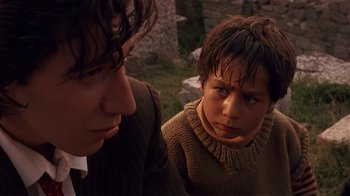Movie still from “Time of the Gypsies” (1988), directed by Emir Kusturica – Two young boys are looking at each other; Close Up shot, Low angle