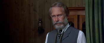Movie still from “Tom Sawyer” (1973), directed by Don Taylor – An older man with a long beard wearing a vest and tie; Close Up shot, Low angle