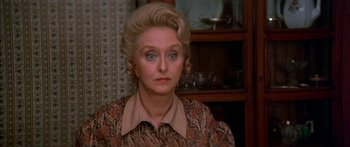 Movie still from “Tom Sawyer” (1973), directed by Don Taylor – An older woman with blonde ringlets in a room; Close Up shot, High angle