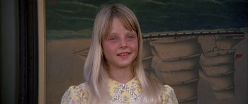 Movie still from “Tom Sawyer” (1973), directed by Don Taylor – A young girl with long blonde hair wearing a yellow dress; Close Up shot, High angle