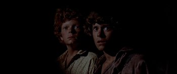 Movie still from “Tom Sawyer” (1973), directed by Don Taylor – A couple of men standing next to each other in the dark; Close Up shot, High angle