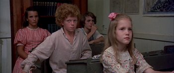 Movie still from “Tom Sawyer” (1973), directed by Don Taylor – A group of people sitting in a room; Close Up shot, High angle
