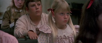 Movie still from “Tom Sawyer” (1973), directed by Don Taylor – A young boy and a young girl sitting next to each other; Close Up shot, High angle