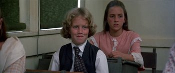 Movie still from “Tom Sawyer” (1973), directed by Don Taylor – Two young children sitting in a classroom together; Close Up shot, Low angle