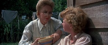 Movie still from “Tom Sawyer” (1973), directed by Don Taylor – An older woman and a young boy holding a bowl; Close Up shot, Over the shoulder angle