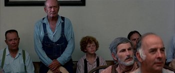 Movie still from “Tom Sawyer” (1973), directed by Don Taylor – A man and a boy sitting next to each other in a room; Medium shot, Over the shoulder angle