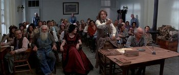 Movie still from “Tom Sawyer” (1973), directed by Don Taylor – A group of people sitting in a room; Wide shot, Over the shoulder angle