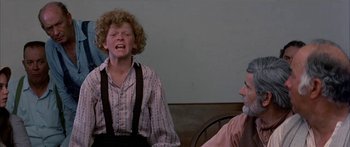 Movie still from “Tom Sawyer” (1973), directed by Don Taylor – A man and a woman sitting on a chair; Medium shot, Low angle