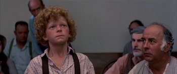 Movie still from “Tom Sawyer” (1973), directed by Don Taylor – A young man with a curly red hair is looking at the camera; Close Up shot, High angle