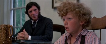 Movie still from “Tom Sawyer” (1973), directed by Don Taylor – A man and a boy sitting at a table; Close Up shot, Over the shoulder angle