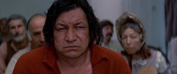 Movie still from “Tom Sawyer” (1973), directed by Don Taylor – A man with long black hair is looking at the camera; Close Up shot, Low angle