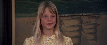 Movie still from “Tom Sawyer” (1973), directed by Don Taylor – A young girl with long blonde hair wearing a yellow dress; Close Up shot, High angle