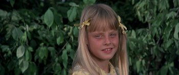 Movie still from “Tom Sawyer” (1973), directed by Don Taylor – A little girl with long blonde hair and yellow ribbons in her hair; Close Up shot, High angle