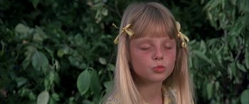 Movie still from “Tom Sawyer” (1973), directed by Don Taylor – A little girl that is sitting in front of a tree; Close Up shot, High angle