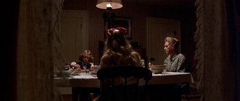 Movie still from “Tom Sawyer” (1973), directed by Don Taylor – A group of people sitting at a table with food; Medium shot, High angle