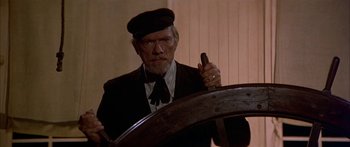 Movie still from “Tom Sawyer” (1973), directed by Don Taylor – An older man wearing a hat and a tie; Medium shot, Low angle