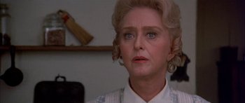 Movie still from “Tom Sawyer” (1973), directed by Don Taylor – An older woman is looking to her left; Close Up shot, Over the shoulder angle