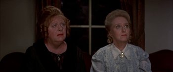 Movie still from “Tom Sawyer” (1973), directed by Don Taylor – Two older women sitting next to each other in front of a window; Close Up shot, High angle