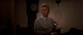 Movie still from “Tom Sawyer” (1973), directed by Don Taylor – A woman holding a candle in a room; Medium shot, Over the shoulder angle