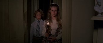 Movie still from “Tom Sawyer” (1973), directed by Don Taylor – A girl and a boy are holding a lit oil lamp; Medium shot, Low angle