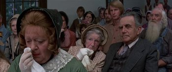 Movie still from “Tom Sawyer” (1973), directed by Don Taylor – An old woman in a crowd of people wearing hats; Close Up shot, High angle