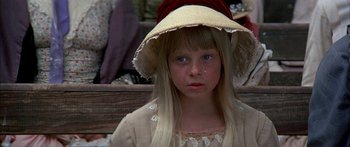 Movie still from “Tom Sawyer” (1973), directed by Don Taylor – A young girl wearing a dress and a hat; Close Up shot, High angle