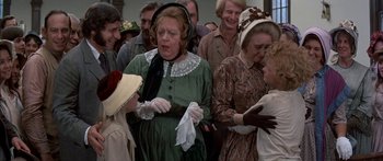 Movie still from “Tom Sawyer” (1973), directed by Don Taylor – A group of people dressed in period clothing; Medium shot, Over the shoulder angle