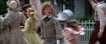 Movie still from “Tom Sawyer” (1973), directed by Don Taylor – A young boy dressed as a man in a costume; Medium shot, Over the shoulder angle