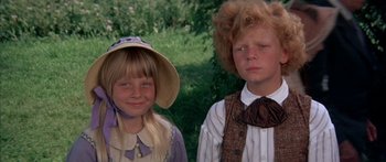 Movie still from “Tom Sawyer” (1973), directed by Don Taylor – A young boy and girl standing next to each other; Close Up shot, High angle