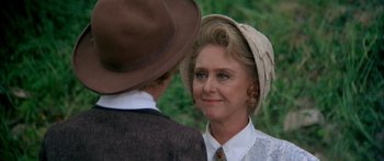 Movie still from “Tom Sawyer” (1973), directed by Don Taylor – An older woman wearing a hat looking at a young man; Close Up shot, Over the shoulder angle
