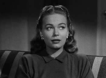 Movie still from “Too Late for Tears” (1949), directed by Byron Haskin – A black - and - white photo of a woman in a black shirt; Close Up shot, Low angle