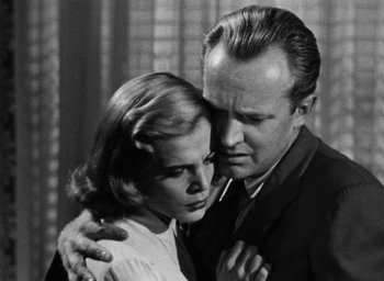 Movie still from “Too Late for Tears” (1949), directed by Byron Haskin – An older man and a younger woman embracing each other; Close Up shot, Low angle