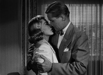 Movie still from “Too Late for Tears” (1949), directed by Byron Haskin – A man and a woman kissing in front of a window; Close Up shot, Low angle
