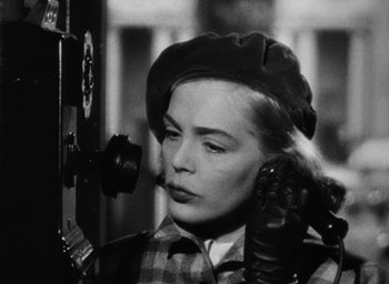 Movie still from “Too Late for Tears” (1949), directed by Byron Haskin – A black - and - white photo of a woman talking on a phone; Close Up shot, Low angle