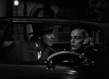Movie still from “Too Late for Tears” (1949), directed by Byron Haskin – A man and a woman sitting in the back seat of a car; Close Up shot, Low angle