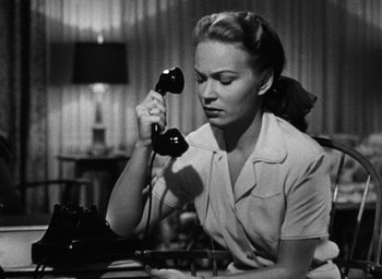 Movie still from “Too Late for Tears” (1949), directed by Byron Haskin – A woman holding a phone up to her ear; Close Up shot, Low angle