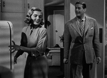 Movie still from “Too Late for Tears” (1949), directed by Byron Haskin – A man and a woman standing next to each other in a room; Medium shot, Low angle